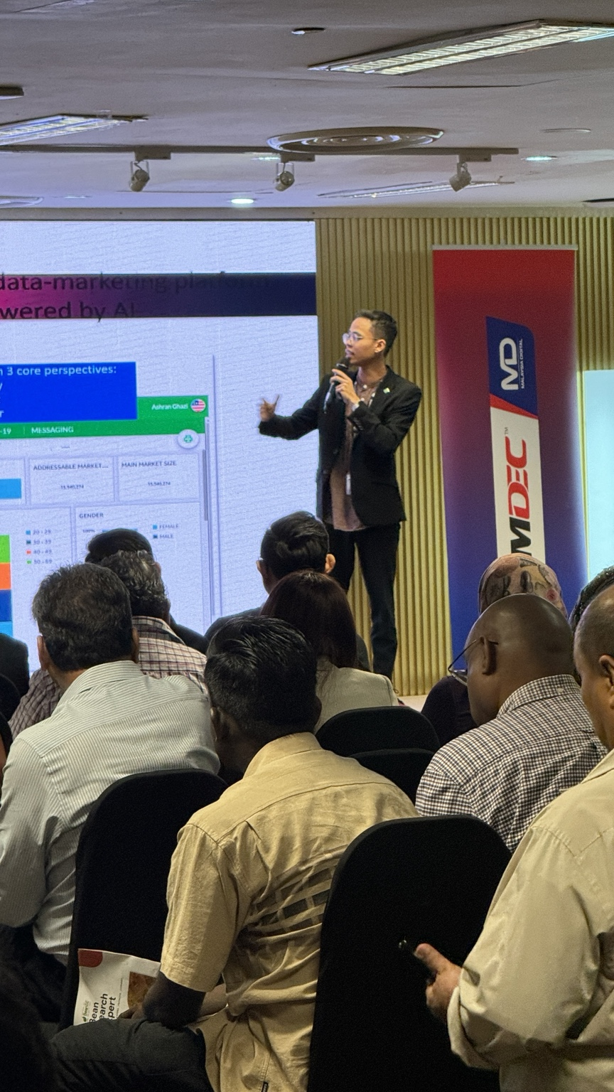 Shazwan presenting on stage